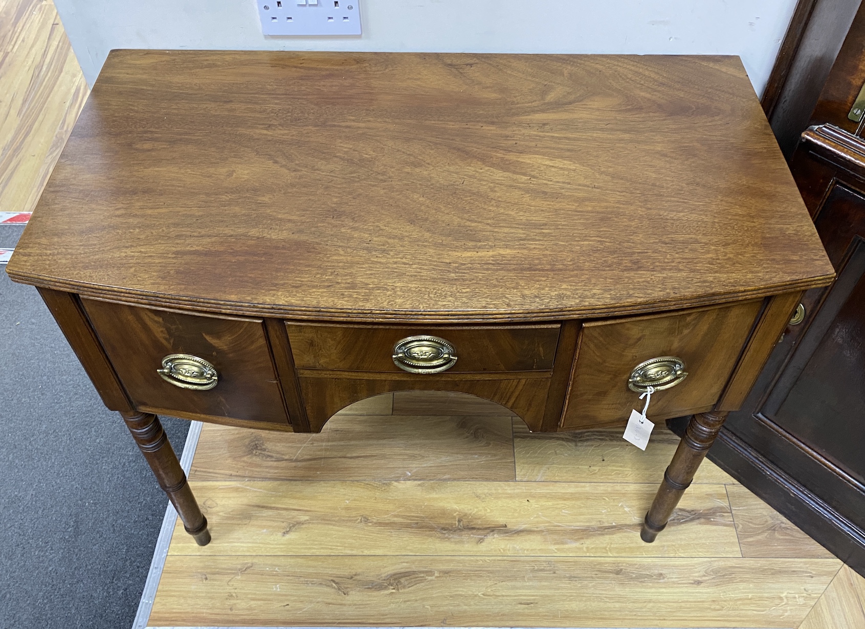 A Regency mahogany bow front three drawer side table, width 95cm, depth 52cm, height 80cm